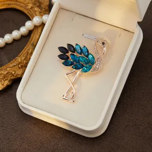 Elegant flamingo brooch crafted with sparkling blue crystals and rhinestones, gold tone.