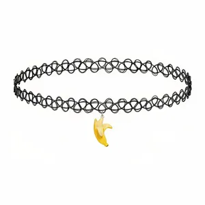 Close-up detail of black tattoo choker necklace with cute yellow peeled banana pendant design.