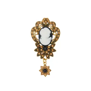 Vintage cameo rhinestone brooch, elegant gold-tone filigree metal pin for women apparel.