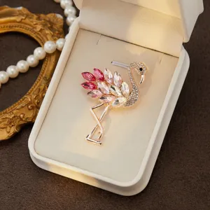 Close-up detail of a sparkling pink crystal flamingo brooch displayed in an elegant jewelry box.