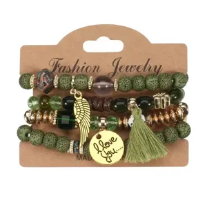 Bohemian multi-layer beaded bracelet set featuring green lava stones, charms, and tassel.
