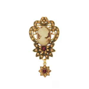 Vintage retro cameo brooch with gold-tone metal, sparkling rhinestones and portrait detail.