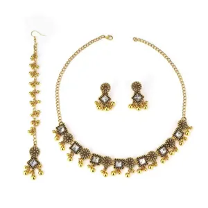 Ethnic style vintage gold necklace earrings and maang tikka jewelry set for women detail.