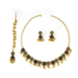 Detail shot of bohemian ethnic gold choker necklace earrings and head chain set with black stones.