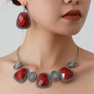 Vintage ethnic style necklace earrings set with red geometric stones and retro silver finish.