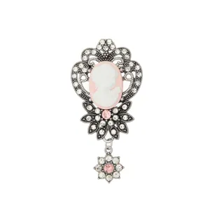 Vintage rhinestone cameo brooch detail, antique silver filigree ornate pin with pink crystals.