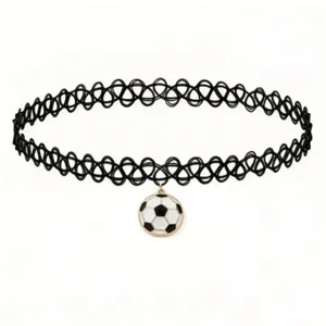 Closeup detail of a black tattoo choker necklace with a cute soccer ball pendant.