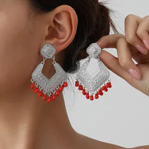 Retro silver geometric tassel earrings with red bead drops, vintage ethnic style ear jewelry.