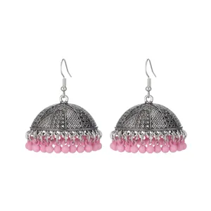 Detailed view of vintage silver tone jhumka earrings with pink dangling bead fringes.