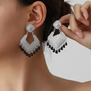 Vintage silver geometric dangle earrings with black bead tassels, retro ethnic style chic.