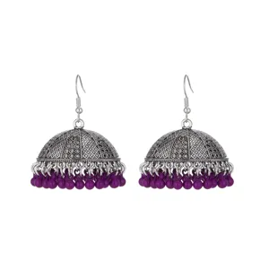 Detailed close-up of ethnic style silver-toned jhumka earrings with purple beaded drapes.
