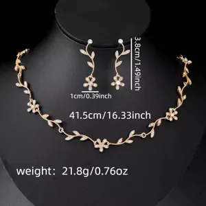 Gold rhinestone leaf necklace and earrings set, elegant floral design fashion jewelry.