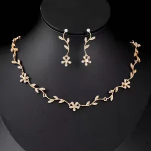 Exquisite gold leaf crystal necklace earrings detail shot, elegant fashion jewelry set view.