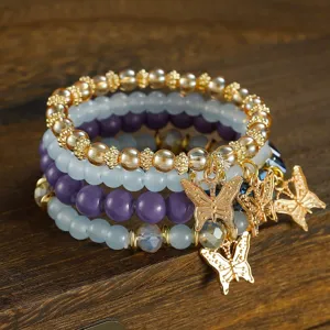 Bohemian multi-layer beaded bracelet set with gold butterfly charms and crystal beads.