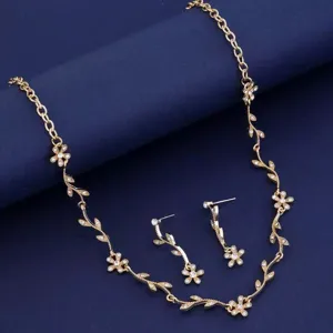 Gold rhinestone floral leaf necklace and matching earrings jewelry set close-up view.