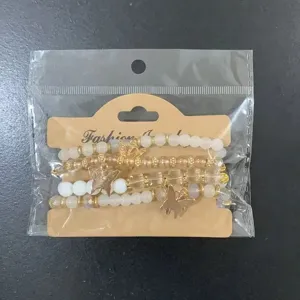 Bohemian multi-layer beaded bracelet set with gold butterfly charms and display card.