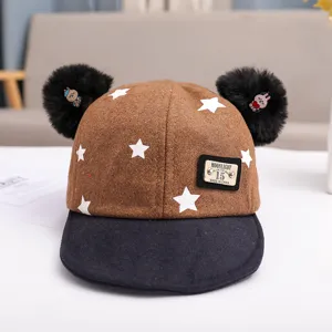 Cute toddler baby winter corduroy baseball cap with cute black pom poms and white stars design.