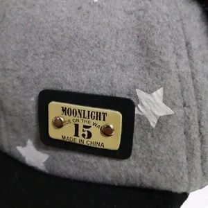 Detailed view of grey kids star baseball cap featuring decorative patch lettering.