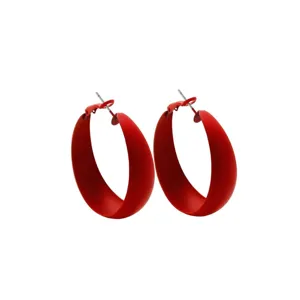 Stylish red chunky hoop earrings for women, modern minimalist geometric circle design.
