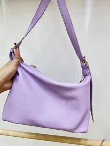 Close-up detail of light purple PU leather shoulder bag with metal hardware and adjustable strap.