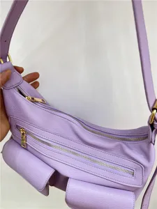 Detailed close-up view of the light purple leather motorcycle shoulder bag with zippers.