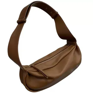 Minimalist brown slouchy hobo shoulder bag featuring a wide strap and soft leather design.