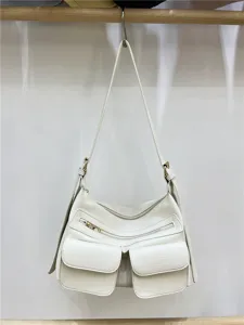 Detailed close-up of white motorcycle shoulder bag showing multiple exterior pockets and zippers.