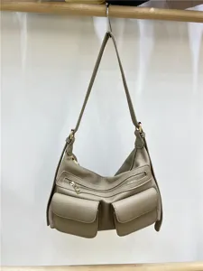 Detail view of a stylish motorcycle style crossbody shoulder bag with multi pockets and zip.