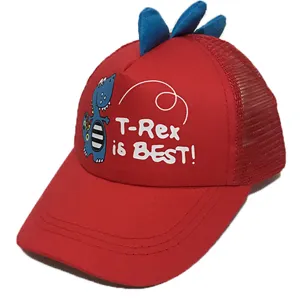 Detail shot of kids red baseball cap with cute blue dinosaur spikes and printed text graphic.