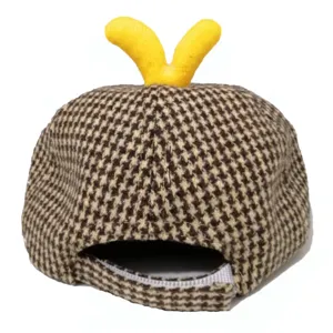 Cute baby hat detail shot, brown houndstooth fabric with playful yellow duck feet on top.