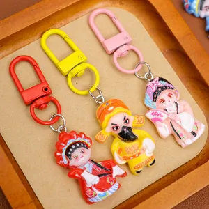 Detailed close-up of cute Chinese opera character keychains, colorful resin bag pendants.