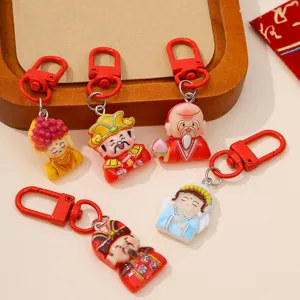 Detailed view of Chinese traditional deity resin keychain charm with red clasp for DIY crafts.