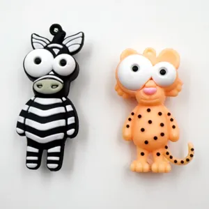 Cute cartoon animal keychain detail showing funny big eyes zebra and leopard charm designs.