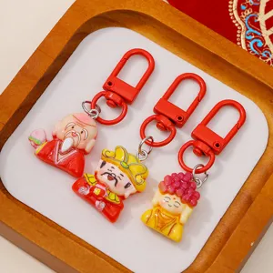 Detailed shot of cute Chinese New Year resin keychains featuring traditional lucky charms.