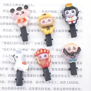 Close-up detail of cute cartoon Journey to the West resin hair clips, kids side clip accessories.