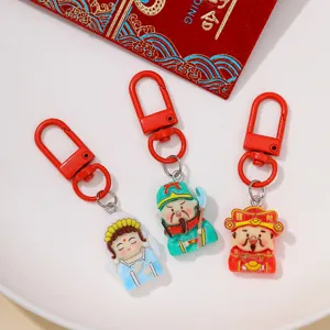 Resin God of Wealth keychain close-up, cute traditional deity pendant for DIY phone cases.