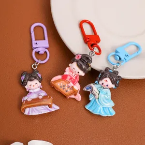 Close-up of traditional Chinese style cartoon girl keychains with musical and chess details.