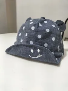 Cute polka dot baby baseball cap with bear ears and soft brim design for infants and toddlers.