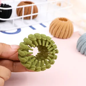 Detail view of velvet bird nest hair clip styling tool, perfect for secure ponytail and bun.