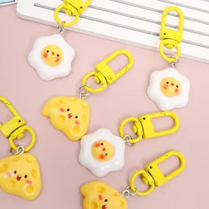 Cute cartoon cheese and fried egg keychains, simulation food bag charms with yellow clasps.
