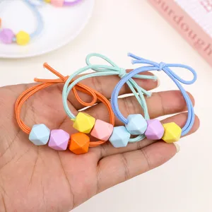 Detail view of colorful geometric hair ties for kids, cute candy-colored elastic hair bands.