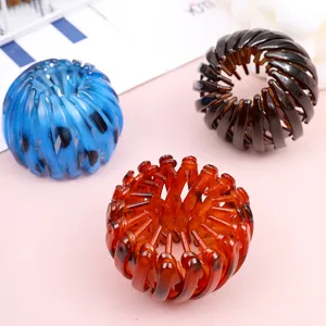 Close-up detail of colorful plastic bird nest hair clips, perfect for stylish hair styling.