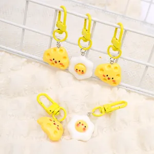 Cute cheese and fried egg keychain detail, resin food play hanging accessory for bag or keys.