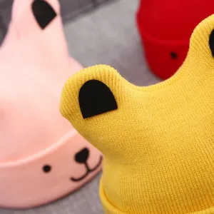 Close-up detail of cute baby knit hat with animal ear design, warm texture, vibrant colors.