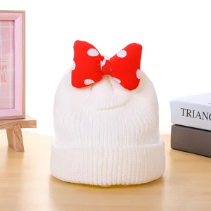 Kids white knitted beanie hat with red polka dot bow, winter warm wool cap for boys and girls