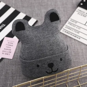 Cute grey knit baby hat detail, adorable bear ears and embroidery design for warm winter.