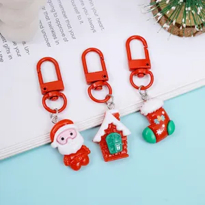 Cute Christmas keychain set featuring Santa, house, and stocking designs for festive gifts.