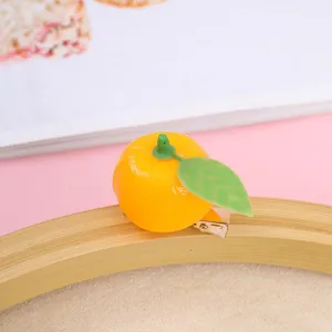 Cute mini orange duckbill hair clip, 3d simulated fruit hairpin detail close up view.