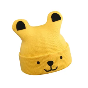 Cute yellow baby knitted beanie hat with adorable animal ears for warm winter wear.