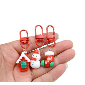 Christmas keychain set featuring cute snowman, house and stocking charms for holiday gifts.